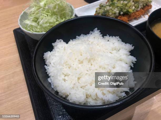 white rice in a black bowl - white rice stock pictures, royalty-free photos & images