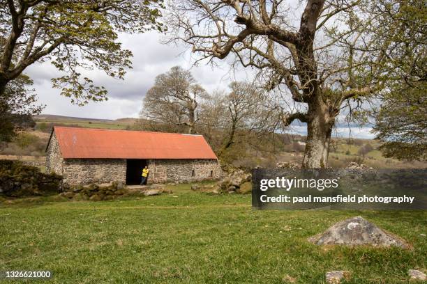 man waiting by stone barn - mansfield england stock pictures, royalty-free photos & images