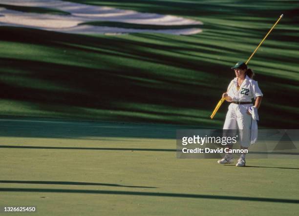 Fanny Sunesson of Sweden, golf caddie for Nick Faldo carries the hole pin across the green on 12th April 1998 during the US Masters Golf Tournament...