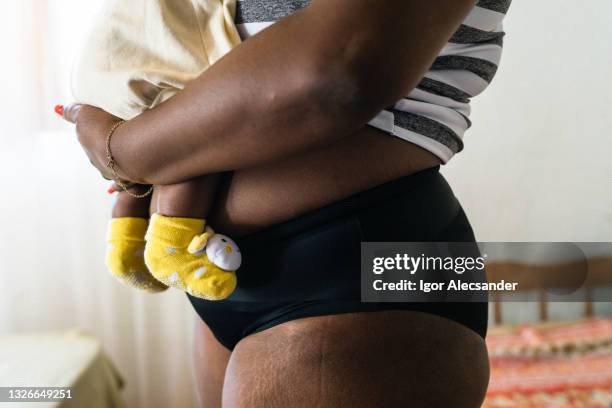 close up of a mother wearing panties holding baby - woman holding tummy bildbanksfoton och bilder