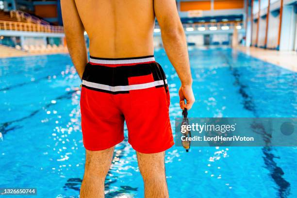 swimmer standing at the poolside - zwembroek stockfoto's en -beelden