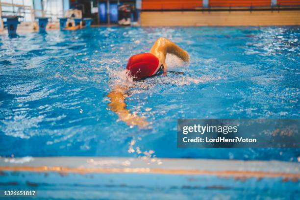 man swimmer swims in the pool - leisure facilities stock pictures, royalty-free photos & images