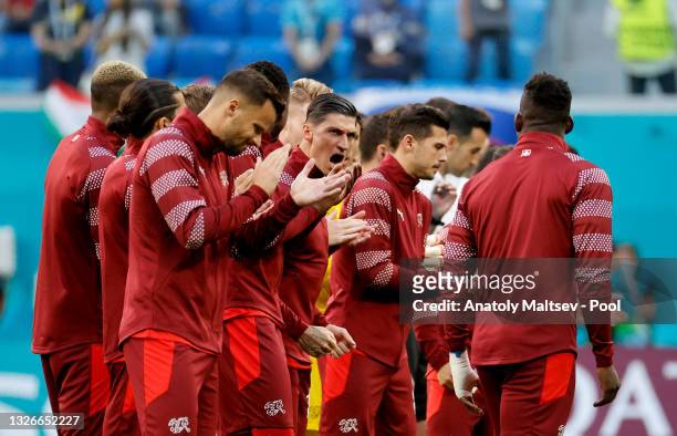 Steven Zuber of Switzerland encourages the team after singing the national anthem prior to the UEFA Euro 2020 Championship Quarter-final match...