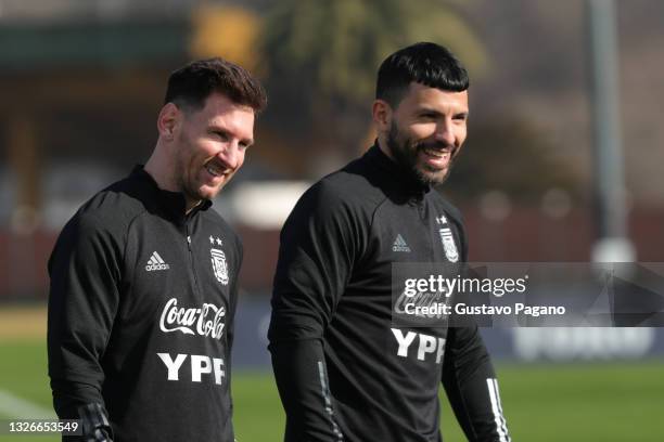 Lionel Messi and Sergio Agüero of Argentina smile during a training session at Julio Humberto Grondona training camp on July 02, 2021 in Ezeiza,...