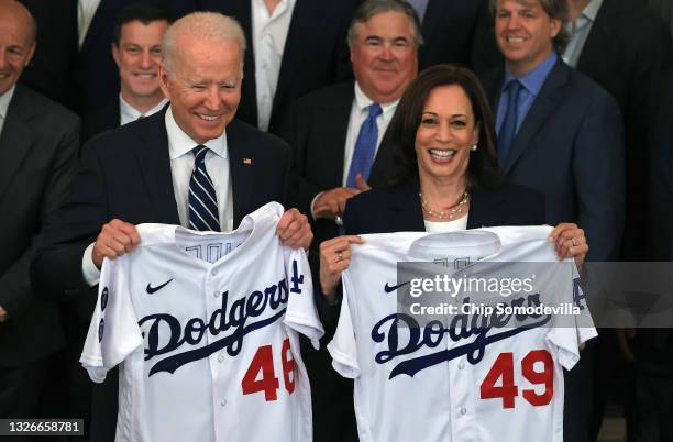 President Joe Biden and Vice President Kamala Harris pose with the jerseys given to them by the 2020 World Series champion Los Angeles Dodgers during...