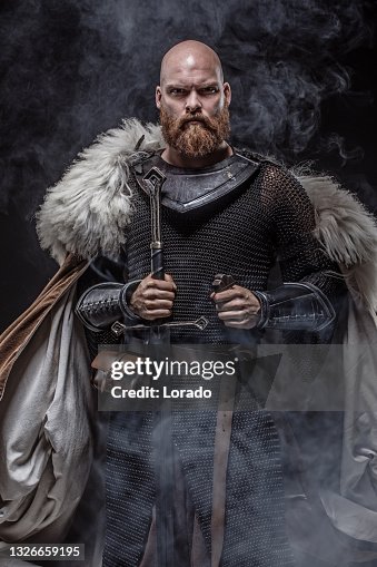 Weapon wielding redhead viking warrior in studio shot Weapon wielding redhead viking warrior in studio shot