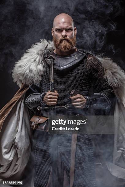 weapon wielding redhead viking warrior in studio shot - viking bildbanksfoton och bilder