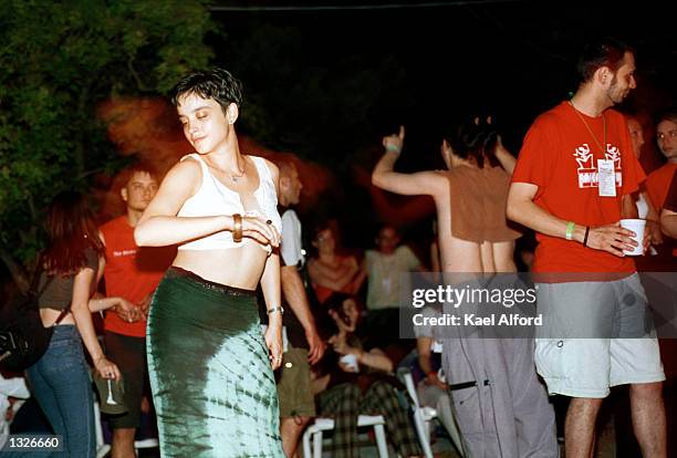 Audience members dance during the performance of the band "Eyesburn" on the final night of the "Exit" music festival July 14, 2001 in Novi Sad,...