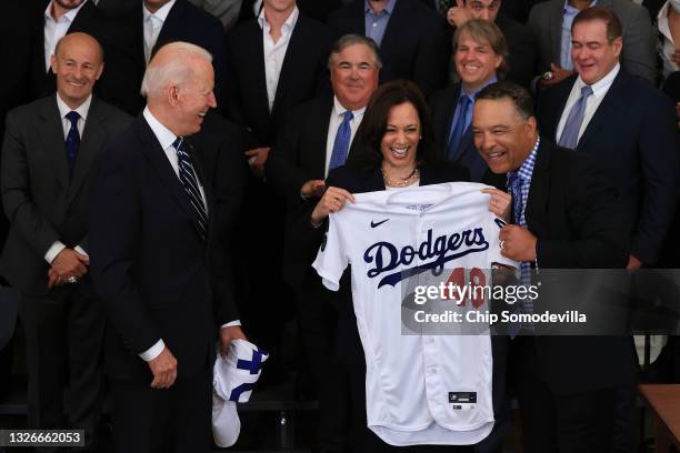 Los Angeles Dodgers Manager Dave Roberts presents U.S. Vice President Kamala Harris with a jersey as she and President Joe Biden host the 2020 World...