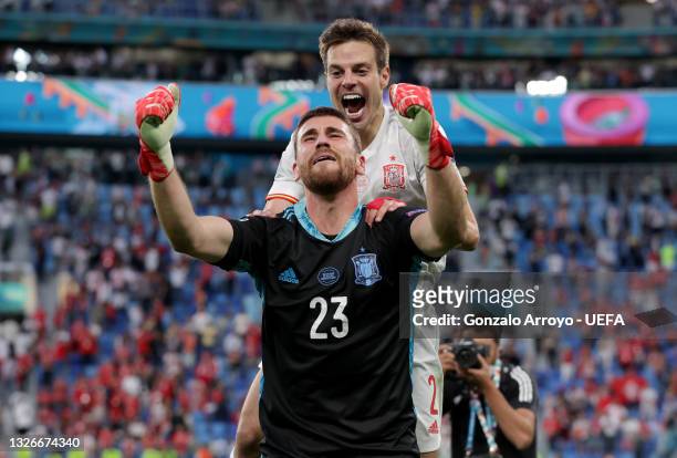 Unai Simon and Cesar Azpilicueta of Spain celebrate following their team's victory in the penalty shoot out after the UEFA Euro 2020 Championship...