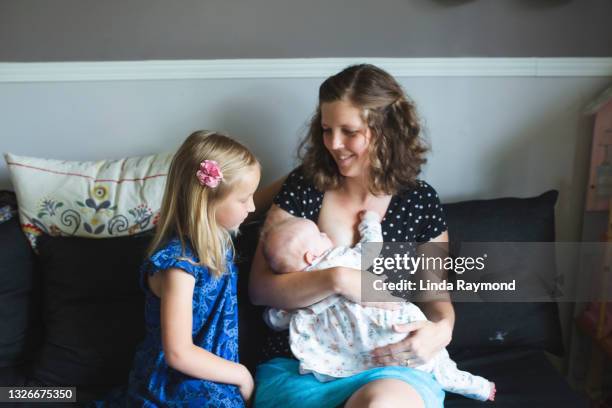 mother breastfeeding - sisters feeding stock pictures, royalty-free photos & images