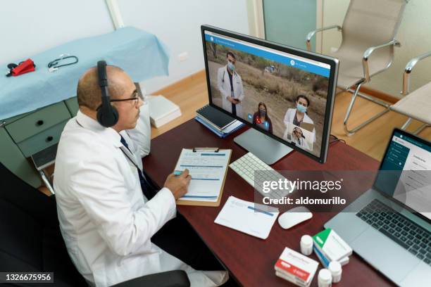 doctor talking to distant medical team at brigade - rural health stock pictures, royalty-free photos & images