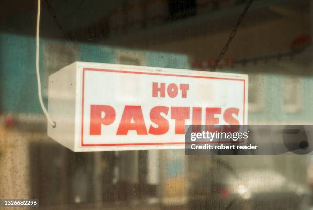 shop window with hot pasties food sign - blätterteigpastete stock-fotos und bilder