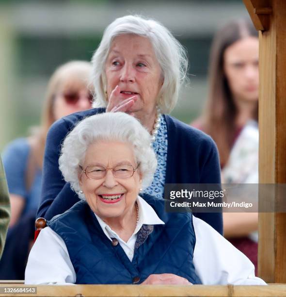 Queen Elizabeth II, accompanied by her lady-in-waiting Dame Annabel Whitehead, watches her horses compete in the Highland and Fells classes on day 2...