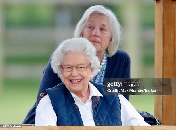 Queen Elizabeth II, accompanied by her lady-in-waiting Dame Annabel Whitehead, watches her horses compete in the Highland and Fells classes on day 2...
