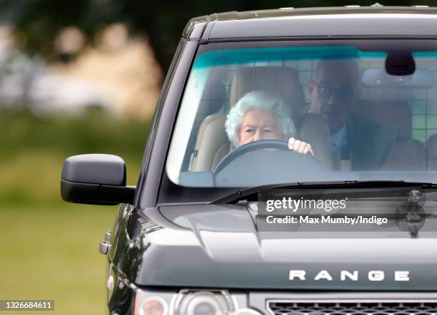 Queen Elizabeth II seen driving her Range Rover car as she attends day 2 of the Royal Windsor Horse Show in Home Park, Windsor Castle on July 2, 2021...