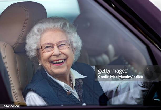 Queen Elizabeth II seen driving her Range Rover car as she attends day 2 of the Royal Windsor Horse Show in Home Park, Windsor Castle on July 2, 2021...