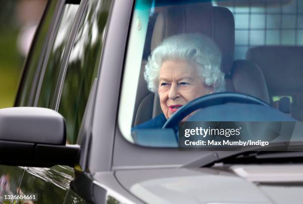 Queen Elizabeth II seen driving her Range Rover car as she attends day 2 of the Royal Windsor Horse Show in Home Park, Windsor Castle on July 2, 2021...