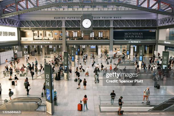 People move through the Moynihan Train Hall at Penn Station before the start of the Fourth of July weekend on July 02, 2021 in New York City....