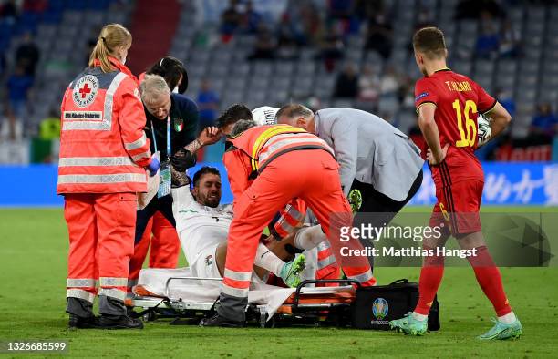 Leonardo Spinazzola of Italy is helped by medical staff on to a stretcher during the UEFA Euro 2020 Championship Quarter-final match between Belgium...