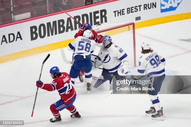 Phillip Danault of the Montreal Canadiens scores a goal past Andrei Vasilevskiy of the Tampa Bay Lightning during the first period in Game Three of...