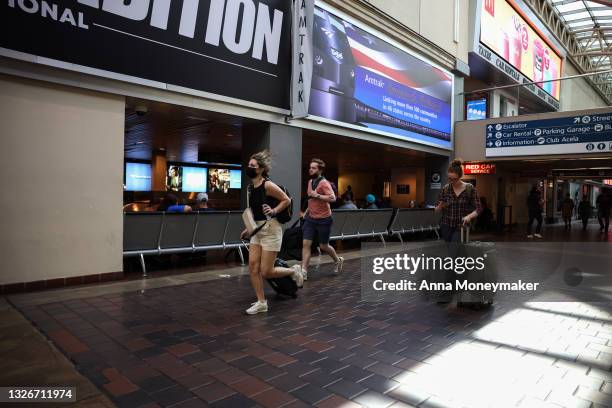 People run through Union Station on July 02, 2021 in Washington, DC. AAA predicts this years July 4th weekend will see up to 47.7 million Americans...