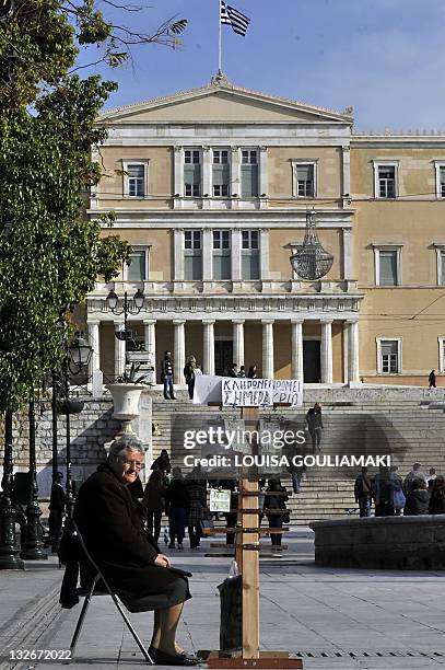 Woman sells lotterytickets at central Athens Syntagma square in front of the Parliament in Athens on November 8, 2011. Greece inched towards a deal...