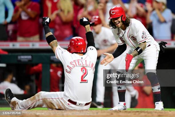 Nick Castellanos and Jonathan India of the Cincinnati Reds celebrate after they both scored on a two-run RBI double by Joey Votto in the sixth inning...