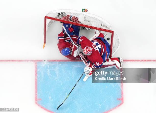 Ben Chiarot crashes into Carey Price of the Montreal Canadiens after a goal by Nikita Kucherov of the Tampa Bay Lightning during the second period in...