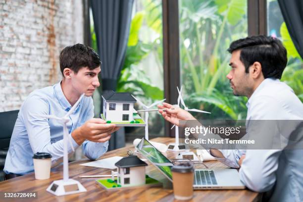 startup for a new project. the architects project team is working at the construction office having a discussion of an architectural design green building structure, follow up a project schedule plan. - new business model stock pictures, royalty-free photos & images