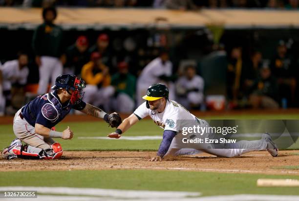 Seth Brown of the Oakland Athletics is tagged out by Christian Vazquez of the Boston Red Sox in the tenth inning at RingCentral Coliseum on July 02,...