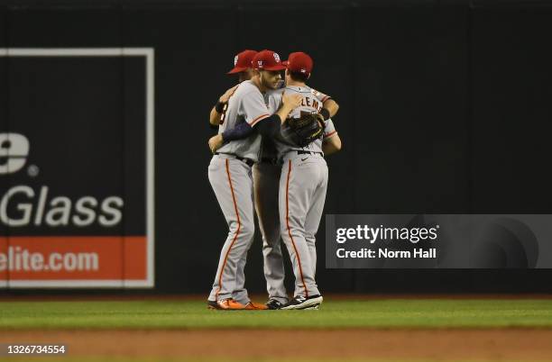 Mike Yastrzemski, Steven Duggar and Austin Slater of the San Francisco Giants celebrate an 11-4 win against the Arizona Diamondbacks at Chase Field...