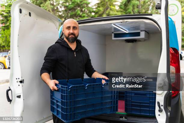 the man working as food delivery person with his van - food transportation stock pictures, royalty-free photos & images