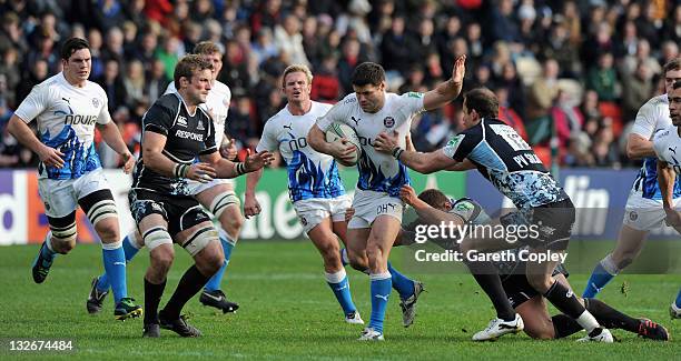 Dan Hipkiss of Bath is tackled by John Barclay, Duncan Weir and Graeme Morrison of Glasgow during the Heineken Cup match between Glasgow Warriors and...