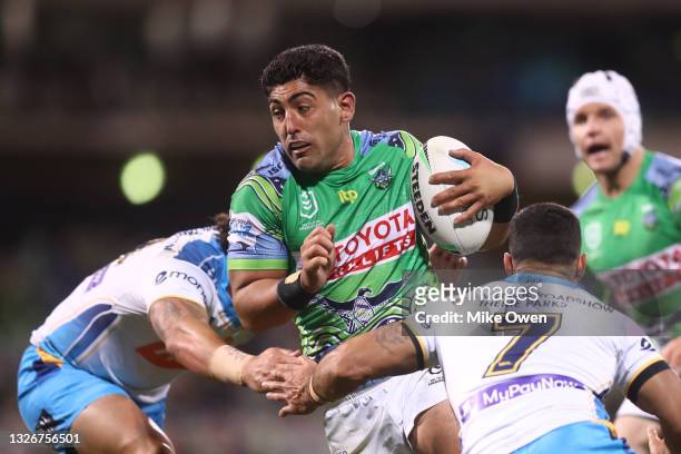 Emre Guler of the Raiders is tackled during the round 16 NRL match between the Canberra Raiders and the Gold Coast Titans at GIO Stadium, on July 03...