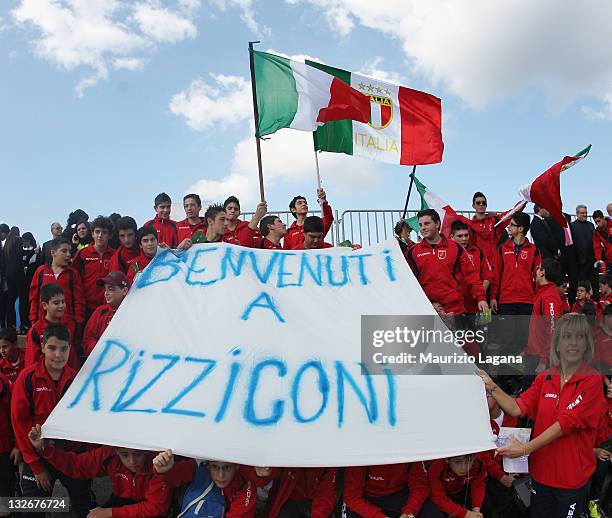 Young Italy fans hold a banner and flags aloft during an Italy training session on November 13, 2011 in Rizziconi near Lamezia-Terme, Italy.