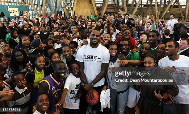 Basketball player LeBron James poses with fans at a Nike event to celebrate the success of the London School of Basketball Comunity League at the...