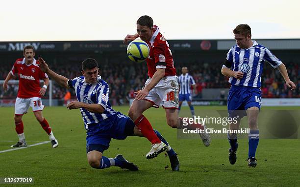 Gary McDonald of Morecambe in action with Danny Batth of Sheffield Wednesday during the FA Cup sponsored by Budweiser First Round match between...