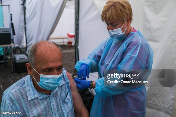 Health worker gives a Johnson & Johnson Covid-19 Jab to a man in a mobile vaccination point on July 03, 2021 in Krakow, Poland. The COVID-19...