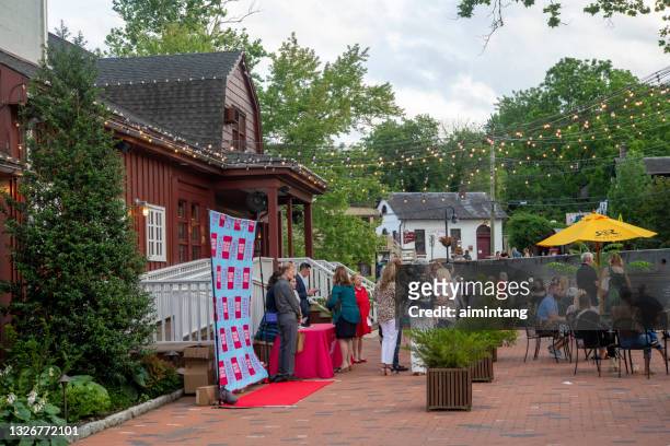people gathering for a party at the front yard of bucks county playhouse - bucks county playhouse stock pictures, royalty-free photos & images