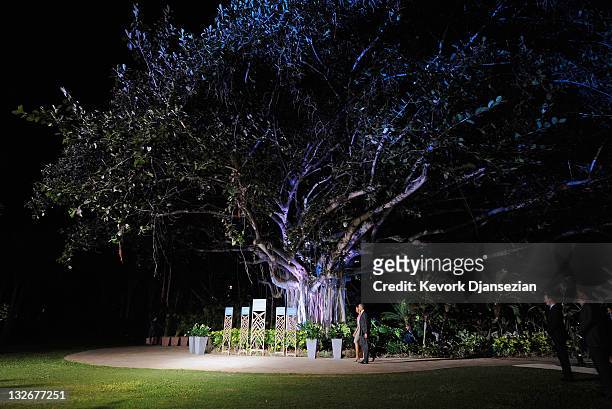 President Barack Obama and first lady Michelle Obama walk under a Banyan tree as they arrive for the welcoming ceremony at the Asia-Pacific Economic...