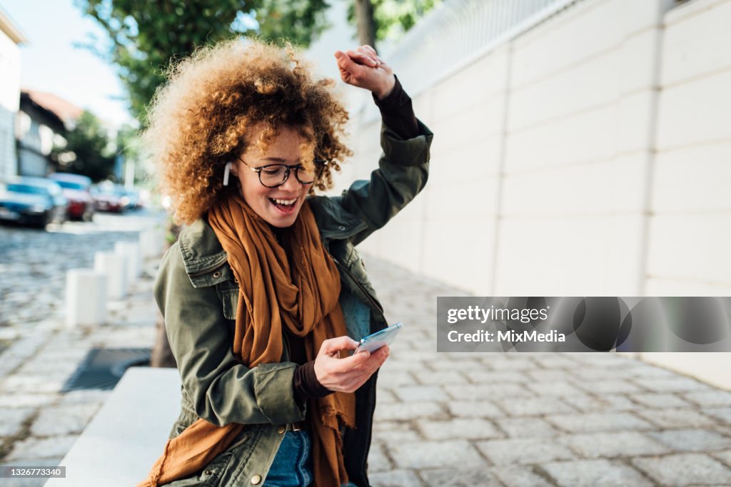 Portrait of a happy girl dancing with her favorite song