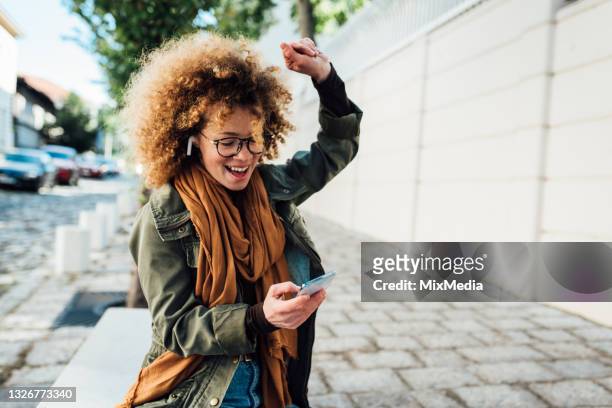 portrait of a happy girl dancing with her favorite song - bluetooth imagens e fotografias de stock