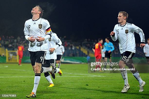 Patrick Weihrauch of Germany celebrates with team mates after scoring his team's opening goal during the U18 International Friendly match between...