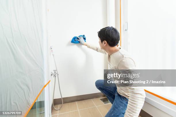 a man painting a wall - rag stock pictures, royalty-free photos & images