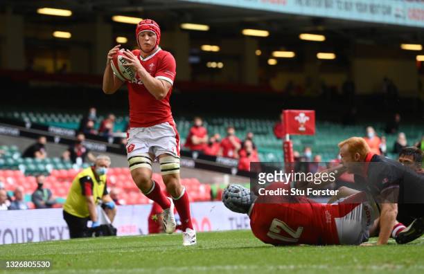 Wales forward James Botham takes a pass from Jonathan Davies to score the first Wales try during the International Match between Wales and Canada at...