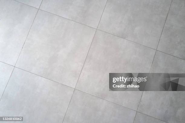 overlooking an empty tile floor - tiled floor imagens e fotografias de stock