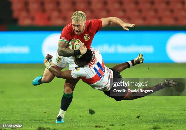 Stuart Hogg of British and Irish Lions is tackled by Rabz Maxwane of Sigma Lions during the 2021 British & Irish Lions tour match between Sigma Lions...