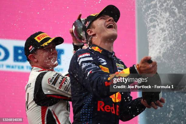 Second placed Frederik Vesti of Denmark and ART Grand Prix and third placed Dennis Hauger of Norway and Prema Racing celebrate on the podium during...