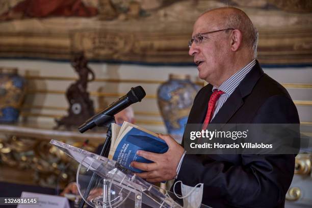 Portuguese Minister of State and Foreign Affairs Augusto Santos Silva holds a copy of "Portugal nas Nações Unidas: 65 Anos de Histórias" as he...